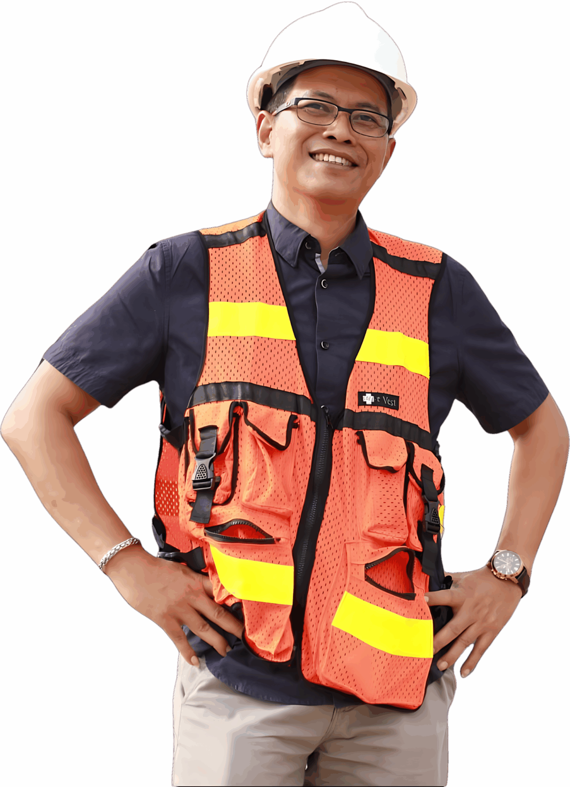 A confident man with short black hair, wearing safety glasses and a blue work uniform.
